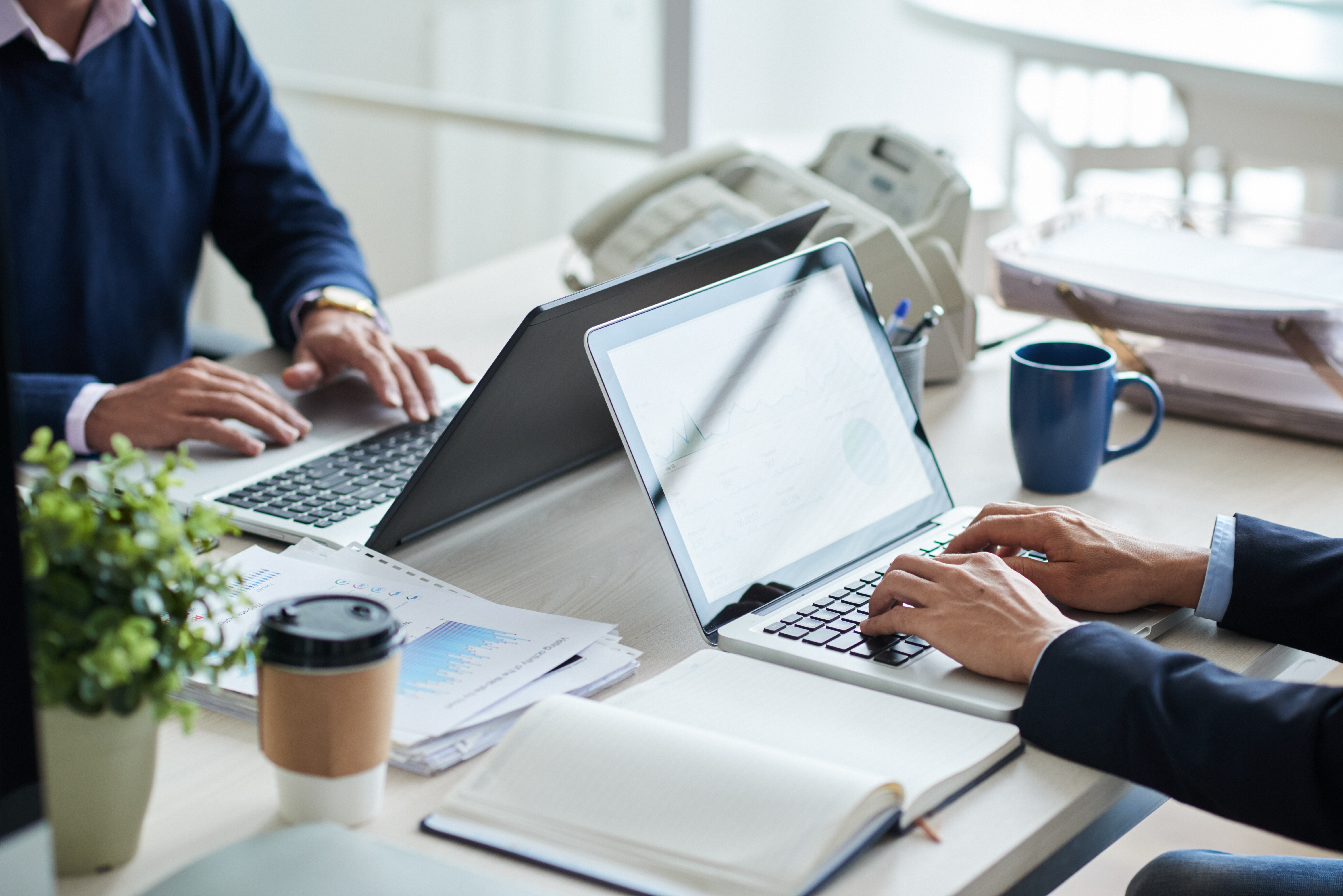 side-view-of-cropped-unrecognizable-business-people-working-at-common-desk